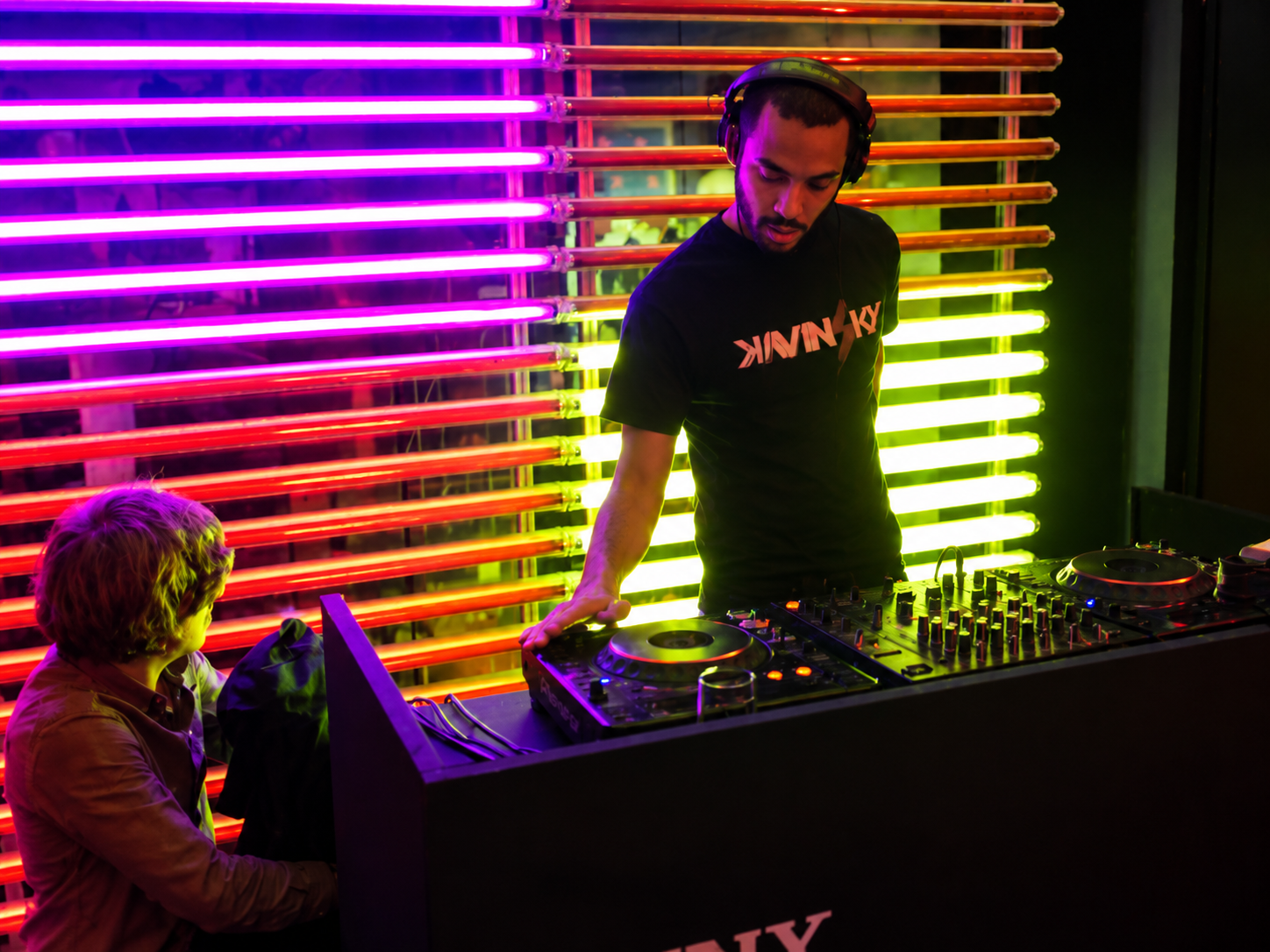 DJ sous des néons multicolores, illustration de la tribune Du Palace à l’IA